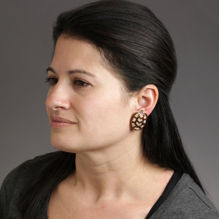These fabulous red enameled 18k gold earrings are miniature Judith Leiber turtle-form purses.  They have a big fashion look -- fun and sophisticated simultaneously.  Set with 1.40 carats of fine white diamonds and an emerald cabochon, they are