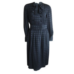 Vintage Elegant black silk dress with attached belt from Norman Norell