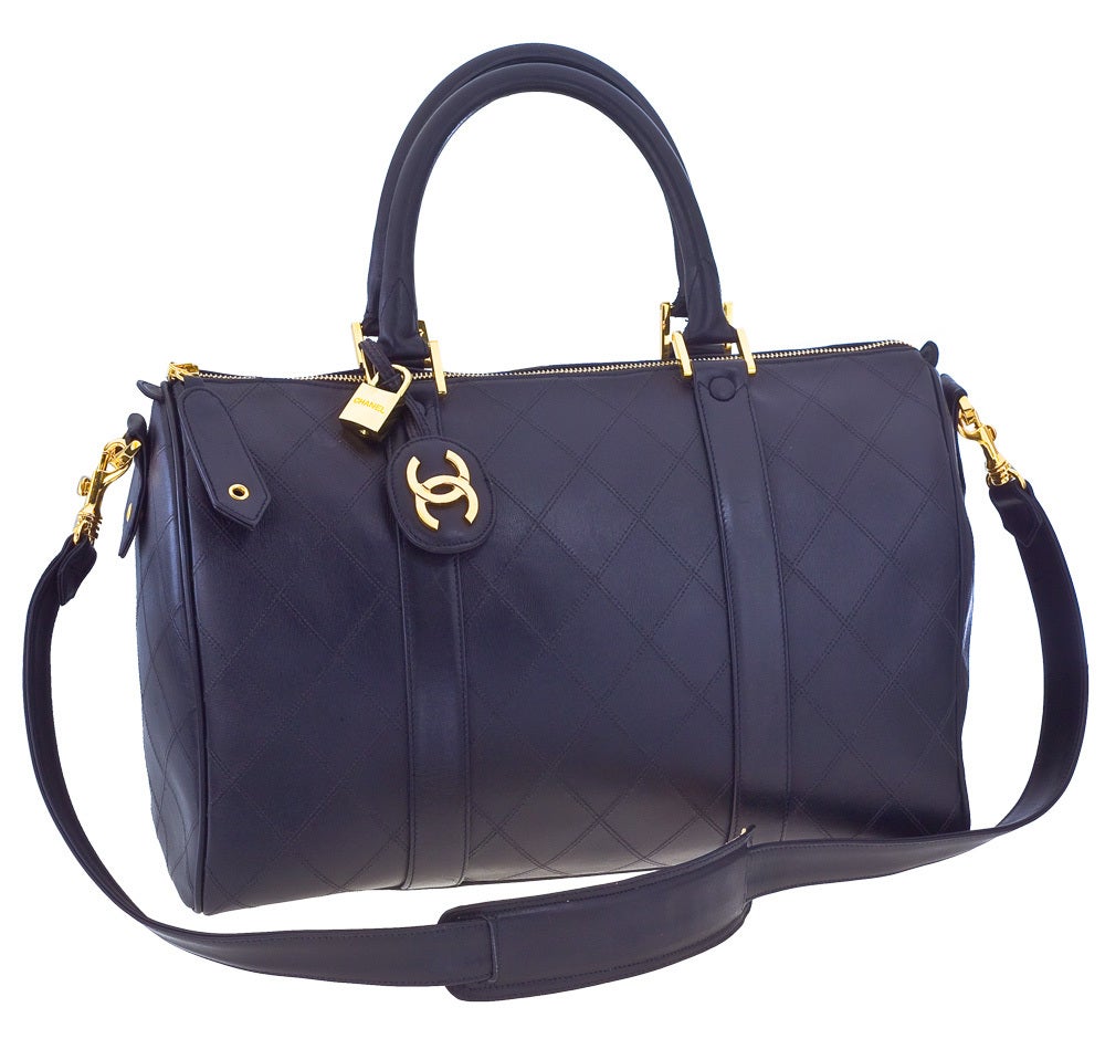 Chanel quilted duffle bag in black.
It comes with a shoulder strap, serial sticker.