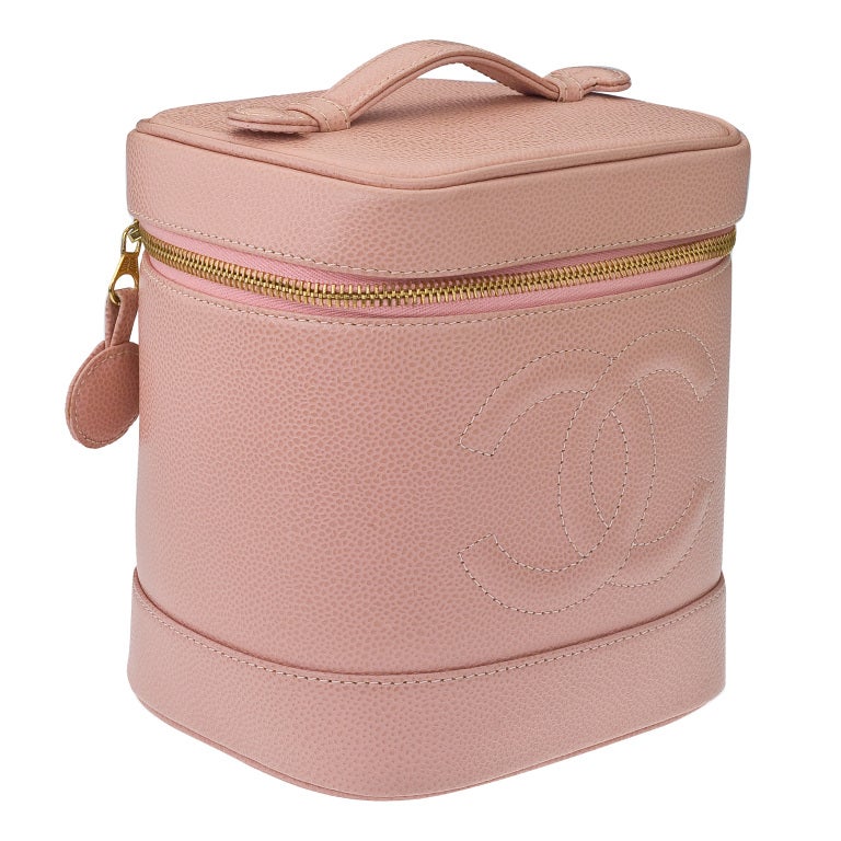 Chanel pink caviar vanity bag with zip closures.