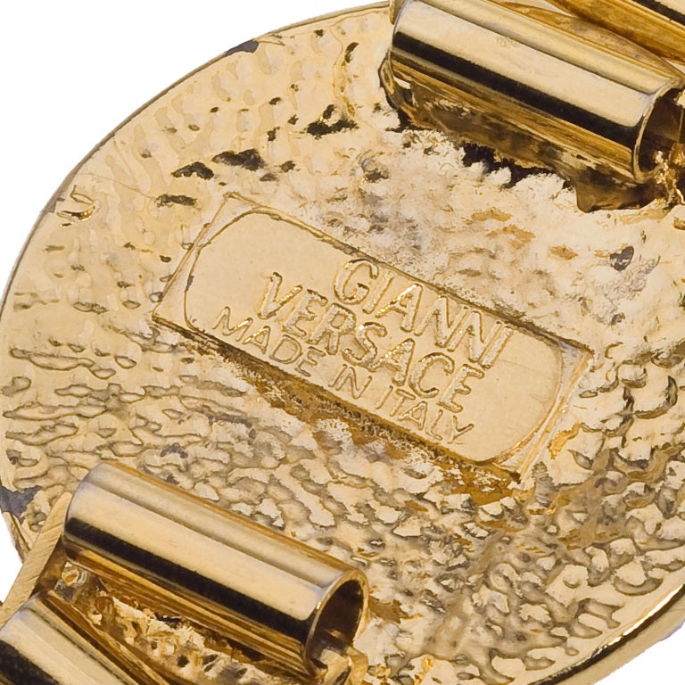 Very rare, massive Gianni Versace gold toned Medusa and Greca motif bracelet with rhinestones.