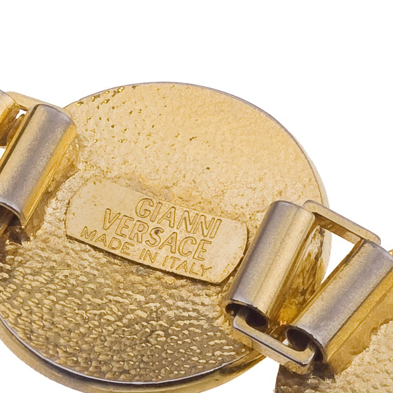 Gianni Versace massive gold toned bracelet with 5 iconic Medusa motifs.