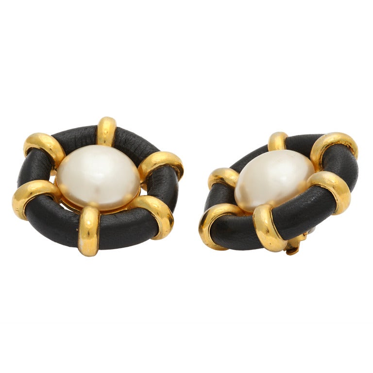 Very rare Chanel marine motif earrings with black leather, faux pearl and gold hardware.