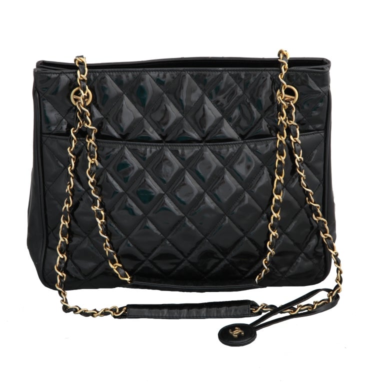 Chanel quilted patent leather shoulder tote bag in black and gold.