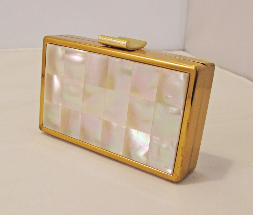 Please contact dealer prior to purchase for White Glove shipping options.

Elqin American Mother of Pearl and Gold Tone Clutch Compact. Has compartments for lipstick, powder, blush, a mirror, and cash/cards.