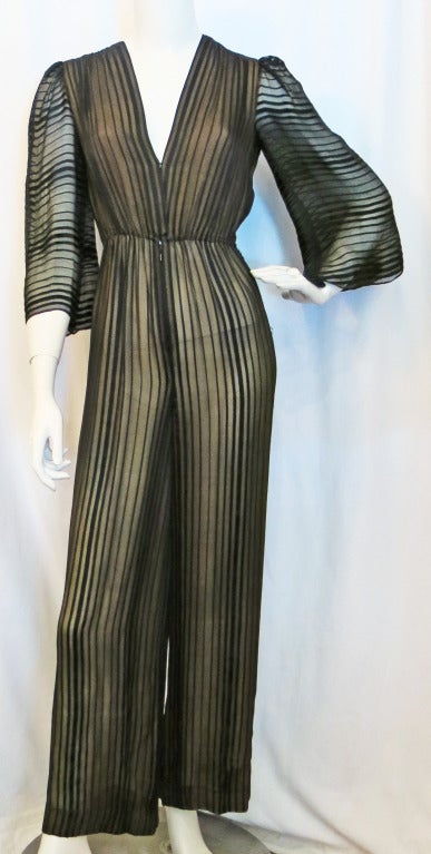 Please contact dealer prior to purchase for White Glove shipping options.

1970s Pauline Trigere for Bergdorf Goodman Transparent  Black and Nude Striped Jumpsuit. Absolutely stunning!