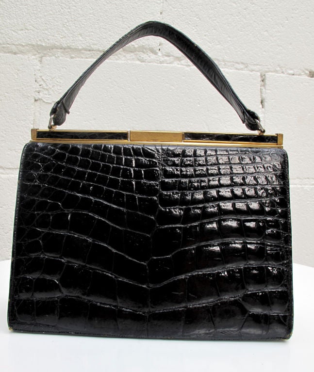 Please contact dealer prior to purchase for White Glove shipping options.

This is a stunning black High Gloss Alligator Handbag from Bellestone. Known for high quality skin bags, this classic shape and size is timeless. Love it now and pass it
