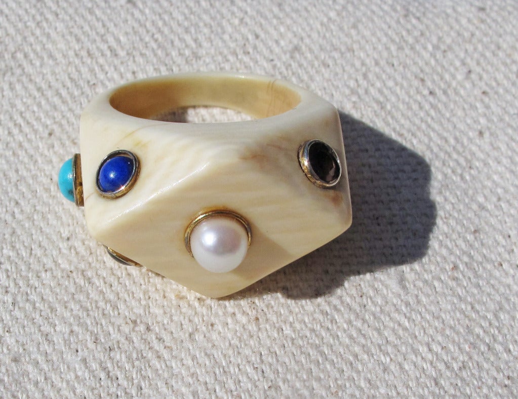Please contact dealer prior to purchase for White Glove shipping options.

Carved Bone Ring with Seven Cabochon Stones in Gold