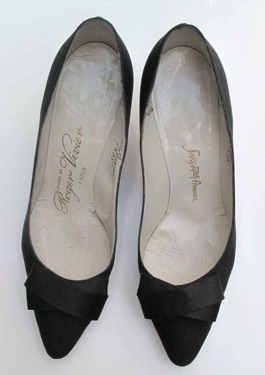 Please contact dealer prior to purchase for White Glove shipping options.

Just as needed as the Little Black Dress, are the shoes to match. These late 1950s Vivier shoes are as simple and chic as they could possibly be. Black with a Cross Over