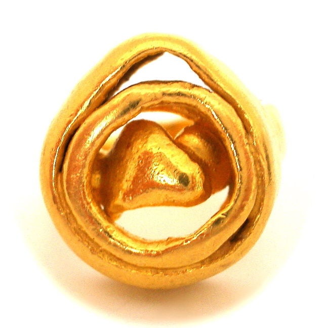 An Art Brute 22k yellow gold ring. The hand fashioned, spiral shaped ring measuring approximately 3/4