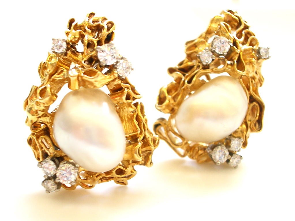A chic pair of 18k yellow gold diamond and South Sea pearl earrings by Gilbert Albert. The 1 1/4 x 1