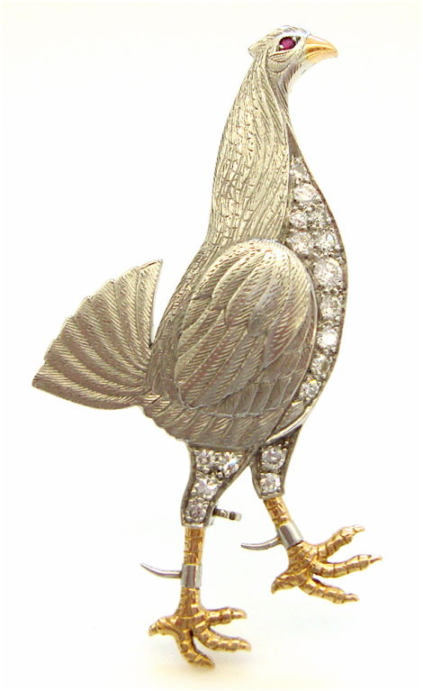 A rare and unusual, platinum, diamond and yellow gold fighting cock pin. The 1 7/8