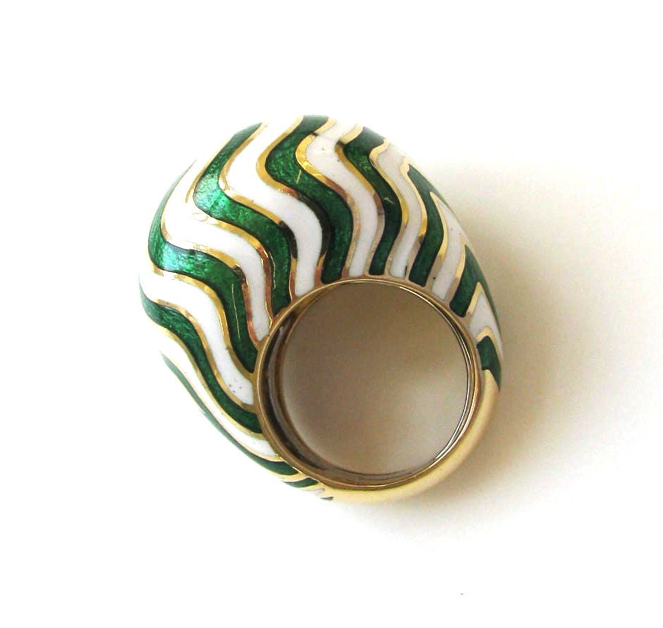 A substantial yellow gold and enamel ring by David Webb. The 18k yellow gold bombe ring with bright white enamel, punctuated by wavy lines of bright apple green guilloche enamel. A pretty ring for spring and summer. Sits 5/8