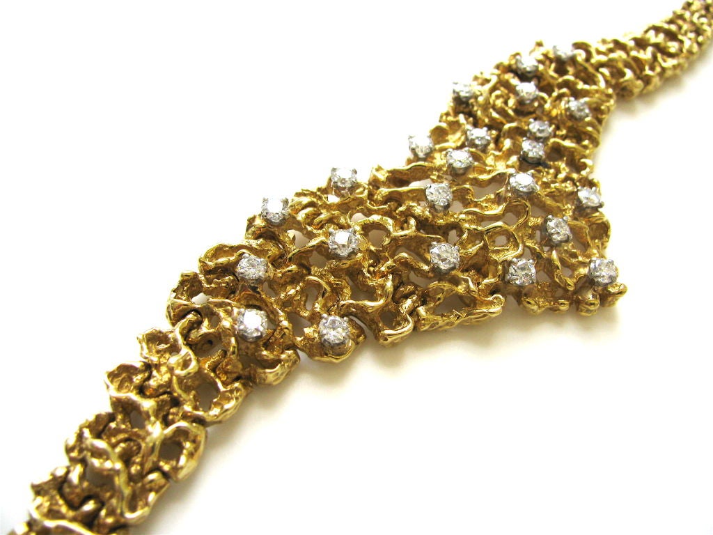 In the style of Arthur King, an elegant yellow gold and diamond bracelet. The 6 1/2