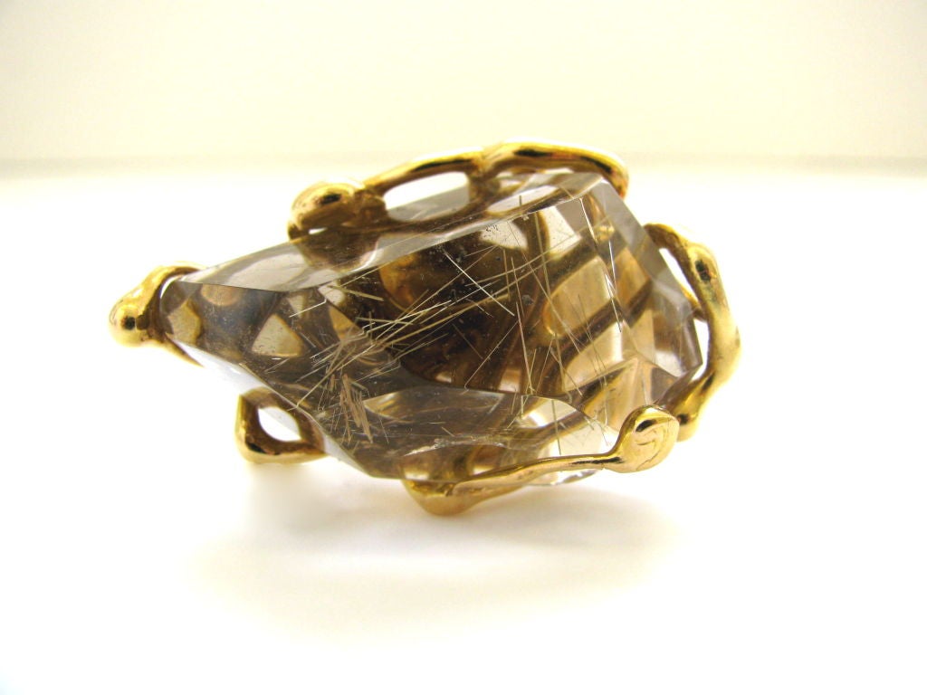 A Substantial gold and rutilated quartz crystal ring. The 18k yellow gold handmade freeform ring with a 1 1/2