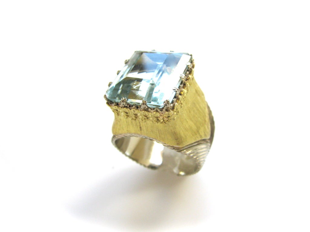 A Lovely gold and aquamarine ring by Buccellati. The white and yellow gold textured split-shank band with a 5/8 x 4/8