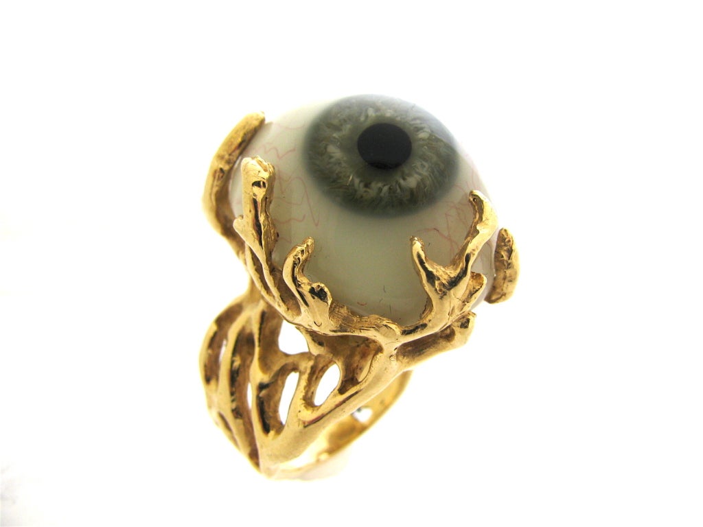 An unusual gold and glass ring. The 14k yellow gold freeform mount featuring a 1