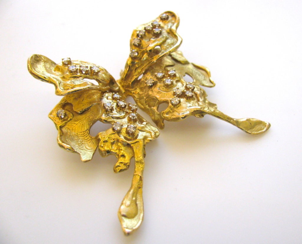 Bett Gury one of a kind moth brooch. The 2 1/4 x 2 1/4 handcrafted 14k yellow gold brooch in the shape of a moth accented with approximately .50cts of round white diamonds and engraved wings. This one of a kind brooch has a rich gold color (it looks