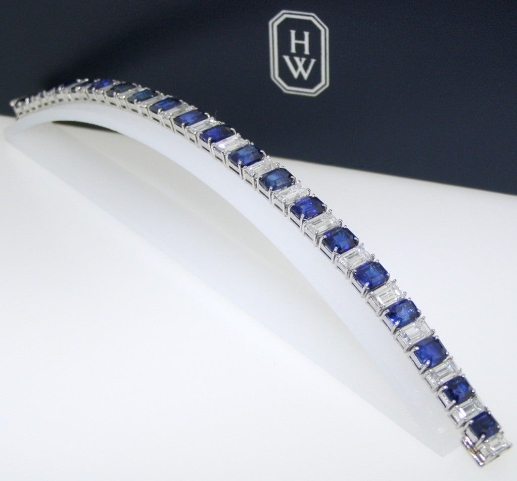 A Sapphire and Diamond Bracelet, by Harry Winston

The straight line bracelet set with alternating emerald cut sapphires and baguette-shaped diamonds; the whole set with 20 emerald cut sapphires weighing 23.34 carats and 20 baguette shaped