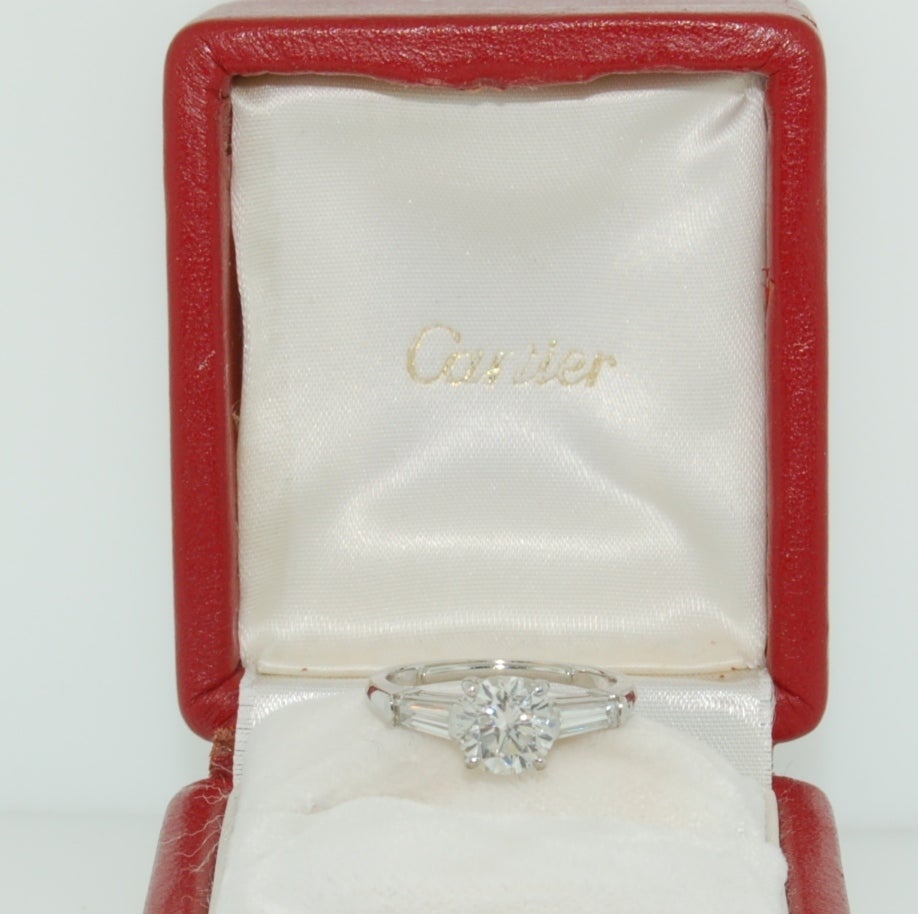 Stunning Cartier platinum round 1.56 carat diamond solitaire with tapered baguettes weighing 0.60 carat.

Color Grade: H

Clarity Grade: VS2

Reference: ZM431001

Serial Number: 803466

Signed 
