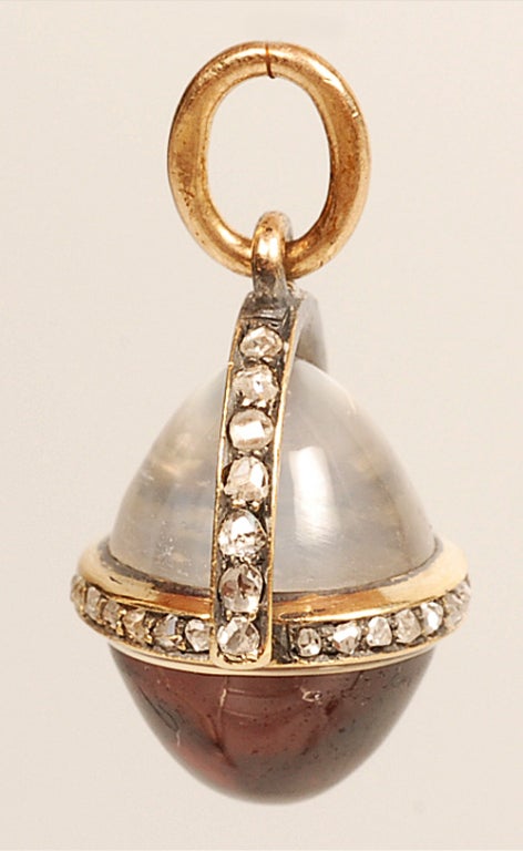 An exceptional and rare Faberge gold, diamond, moonstone and garnet miniature egg pendant, workmaster August Hollming, ST Petersburg, circa 1890, the 