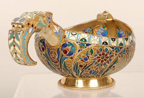 A Russian gilded silver, plique-à-jour, and cloisonné enamel kovsh, Moscow, 1899-1908; apparently no maker's mark, but undoubtedly by Ovchinnikov. Of traditional form with raised prow and flaring base, the body decorated with a river- or lakeside
