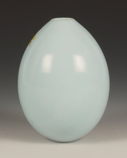 A Russian porcelain Easter egg decorated with vibrant floral sprays against a pale blue ground. Height: 4 1/8”.
