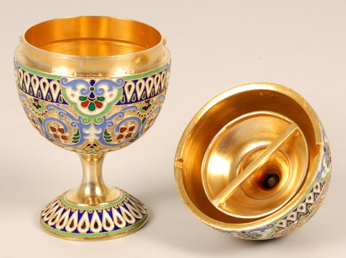 A Russian silver gilt and cloisonné enamel Easter egg, 11th Artel, Moscow, 1908-1917. The exterior enameled with stylized geometric and foliate ornament in shades of periwinkle blue, apple green, red, navy blue, and opaque white, all against a