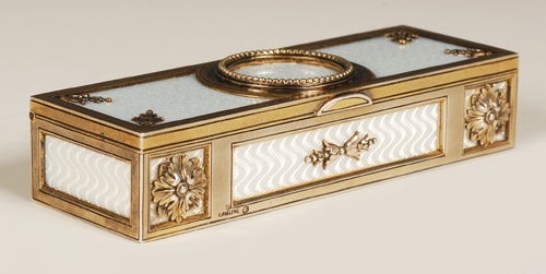 A Faberge silver gilt and translucent white enamel stamp box, Moscow, circa 1896-1908. Of rectangular form, the interior divided into three compartments for different denominations of stamps, the exterior decorated with white translucent enamel over