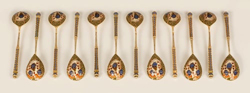 A set of twelve Faberge silver-gilt and shaded cloisonne enamel teaspoons, workmaster Feodor Ruckert, Moscow, circa 1908-1917, scratched inventory number 25218. The reverse of each bowl is enameled with Pan-Slavic style shaded polychrome stylized