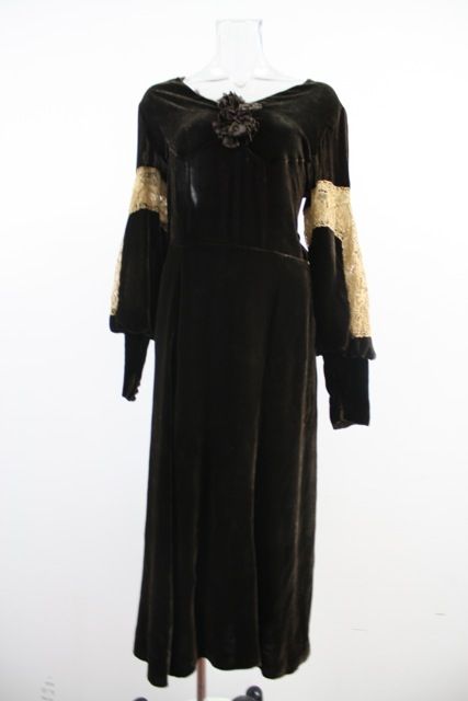 Luscious  rich chocolate brown silk velvet evening dress in a tea length. Very Boardwalk Empire. It has a raglan sleeve that gathers above the wrist. accented down the sides with a dark ivory inserted Chantilly lace.  It has a wide portrait neckline