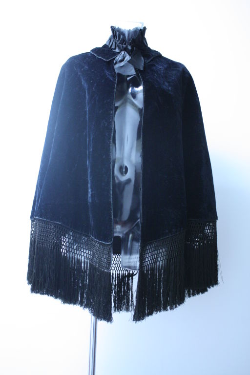 Victorian velvet and silk cape with a beautiful detailed embroided piano fringe. Elegantly constructed high neckline with silk ribbon ruching completed with a black velvet collar. Perfect for stepping out in your horse-drawn carriage for a night at