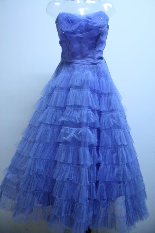 This formal vintage party dress, by Cotillion Originals, would be perfect for prom or a special spring event. The dress is made of beautiful layers of ruched periwinkle blue netting and the strapless, shelf style bodice has an under layer of