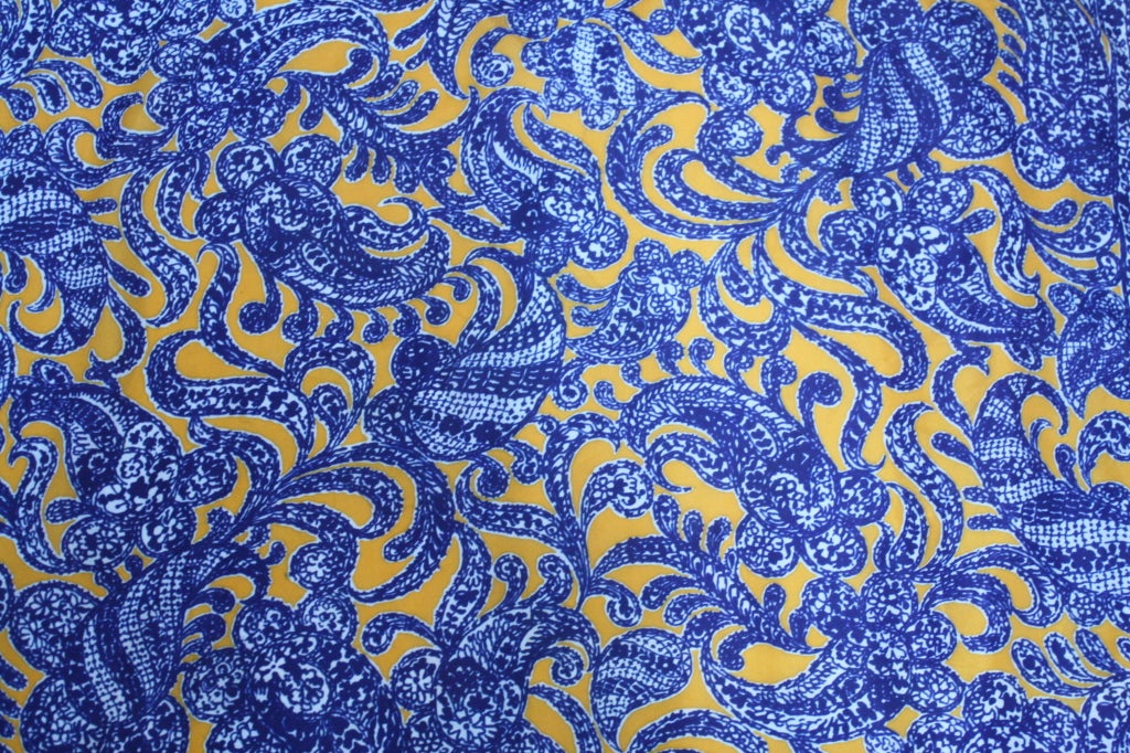 Elsa Schiaparelli is  the definitive surrealist fashion designer of the 20th Century. This 100% silk Wedgewood China blue and golden rod paisely -esque print scarf was from a 1970's run of limited edition scarves designed by Schiaparelli. It is