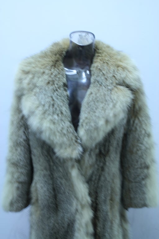 Gorgeous Canadian Lynx full length fur coat! Beautiful styling with a shawl tuxedo collar. Light Lynx spots indicate a beautiful winter fur. Full length sleeves and unique fur covered oversized buttons. Cuddle up in luxury!
