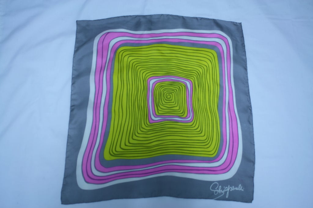 Elsa Schiaparelli is the definitive surrealist fashion designer of the 20th Century. This 100% silk mod optical illusion print in chartreuse, dove and shocking pink was from a 1970's run of limited edition scarves designed by Schiaparelli. The scarf
