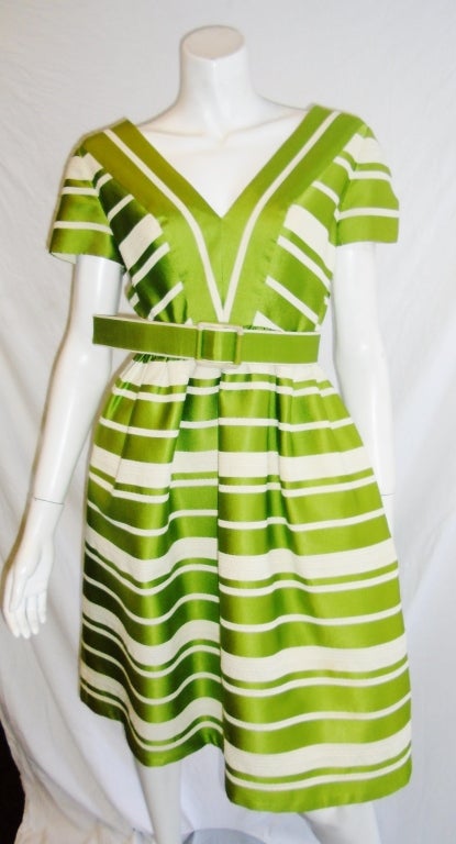 Beautiful green twill  and white silk ribbed dress. Very difficult to describe beauty of the fabric. Short sleeves and belt. Pristine condition. 
Bust 40