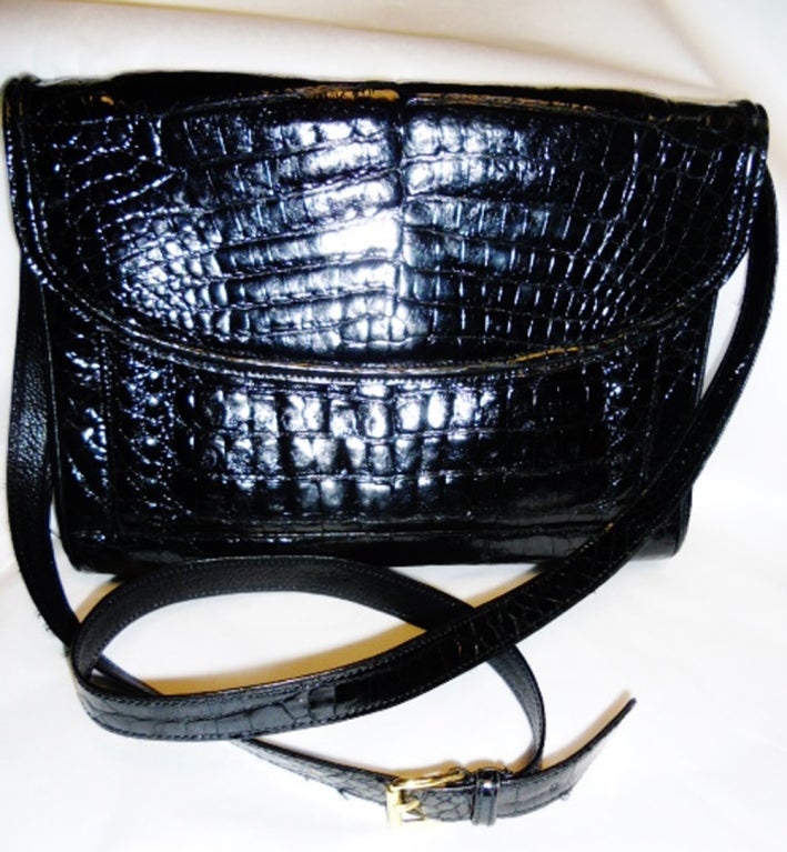 Donna Elissa genuine alligator cross body/clutch bag, 2 compartments , 1 zipper closure pocket, 1 outside magnetic closure pocket, flap closure, removable adjustable shoulder strap. Long enough to be worn as a cross body bag during the day, and as a