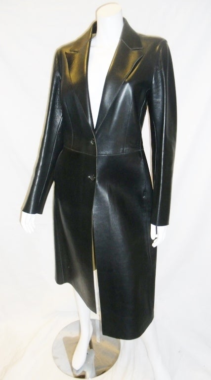 Stunning and a must have double leather Prada coat for fall. Simple straight clean lines. Buttery soft double leather black and tan. Two front button closure.. Back slit. Notched collar. It will look great with boots, cashmere sweater jeans  or