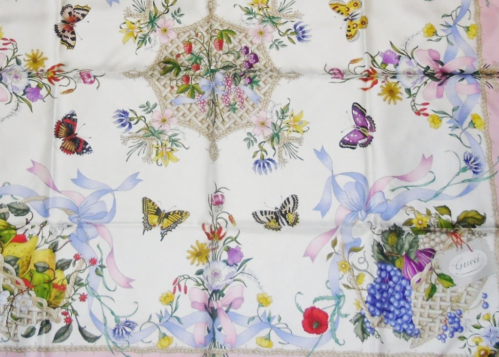 Gorgeous silk twill scarf by Gucci. Ivory base, lite pink border  trim with lavender and lite blue ribbons. Butterflies and baskets of fruit and berries. Incredibly detailed. 35