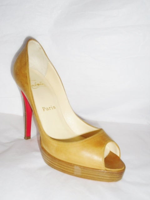 classic Christian Louboutin Altadama 120mm Leather Peep Toe Pumps  in tan soft leather. Stacked heel and wood platform . Used once or twice in pristine condition without signs of wear except on the sole. 
  Size 37.5 
Sorry No Box