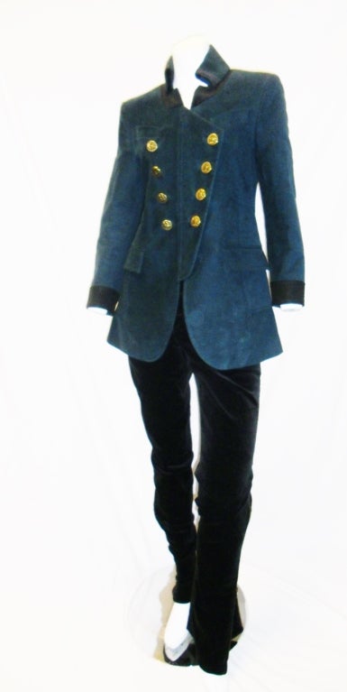 Fabulous military  style Gucci jacket and pants. Military blue jaklet.  Concealed Zipper closure velour fabric with Vintage Gucci insignia buttons.Back vent. Black velour cuffs and collar.  
Riding Pants are jeans style top . Boot cut. Tight at the