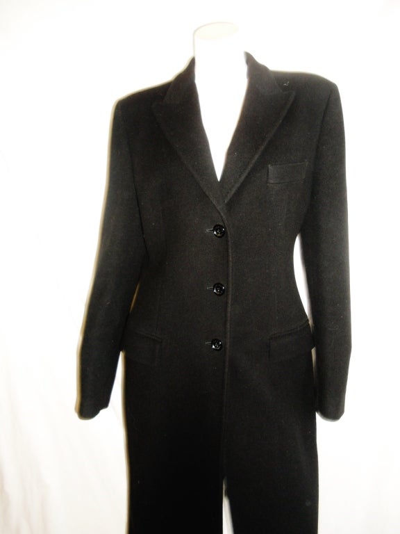 Fabulous in every way and always in fashion.  Classic cut tailored Black wool and cashmere blend . Front button closure . Flap pockets . Back vent. Red logo lining. Pristine condition.
Size 42. 
Shoulders 16
