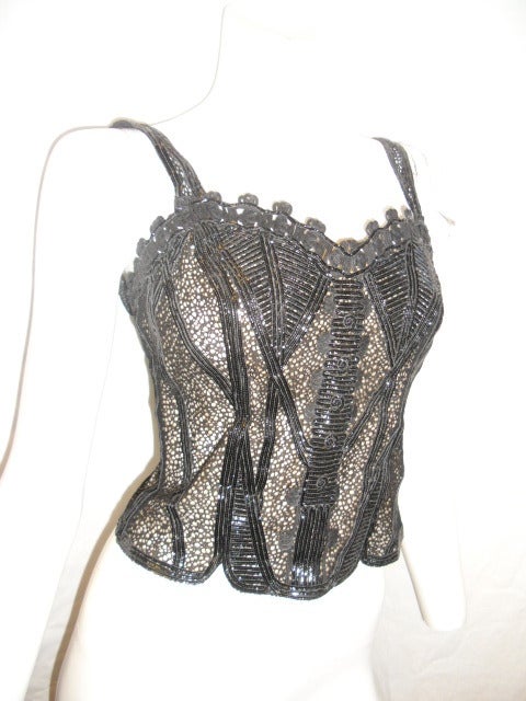Valentino black corset style top.  Nude silk lining with Spectacular intricate work of strips of patent leather in combination with lace. Back zipper closure. 
Size 4-6 bust 34-36