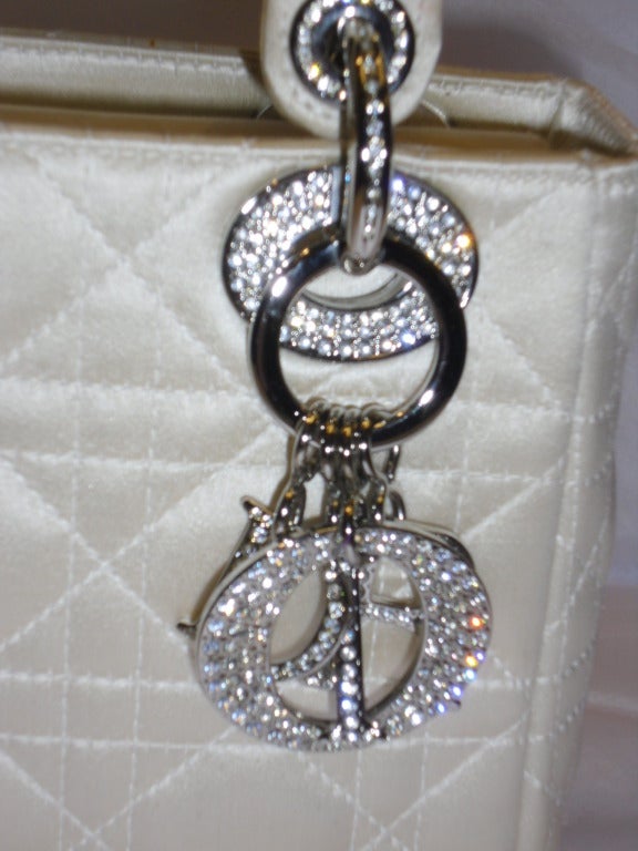 CHRISTIAN DIOR Silk Swarovski Crystal Cannage Evening Lady Dior in Ivory. This stylish small tote is crafted of geometric quilted fine  silk. The bag features  top handles with silver hardware including wide eyelets and a Dior name charm each