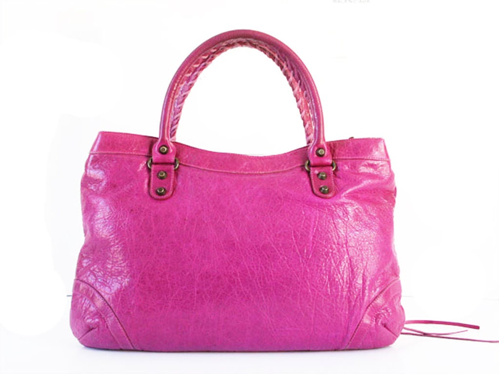 Simply stunning, this Balenciaga '05 Magenta Purse shows off one of the hottest, holy grail colors ever made! This bag is in excellent condition with light patina on the handles Its leather feels totally amazing, super soft and silky 2005 goatskin