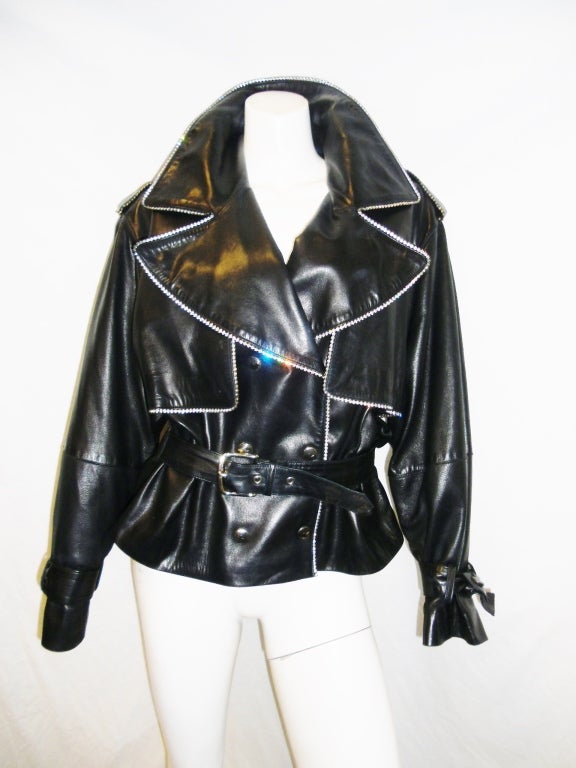 Buttery soft Amazing CHARLES JOURDAN leather Bike  jacket with rhinestones trim. Belted at the waist. Double breasted snap front closure.  Mint condition. Size 40
Bust 44