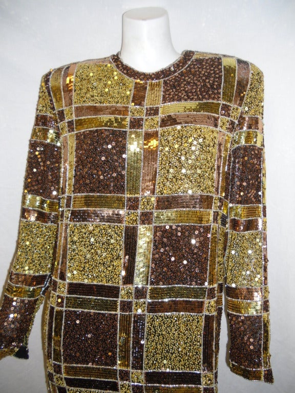 Exploding with tones  of Gold and bronze  colors , choices of carefully picked sizes of beads and sequent and than all hand sewn into a spectacular Art deco pattern. All Silk shift dress by Naeem Khann. Made in India.  Pristine condition. 
Size