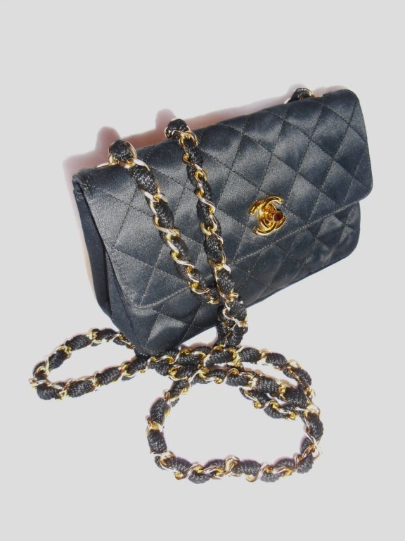 Fabulous small Evening Chanel 2.55 Black silk Chanel bag. Big enough for all your necessary items  and small enough to carry around all night long. Gold tone hardware. Pristine condition. Dust bag included. 
Bag measures 7