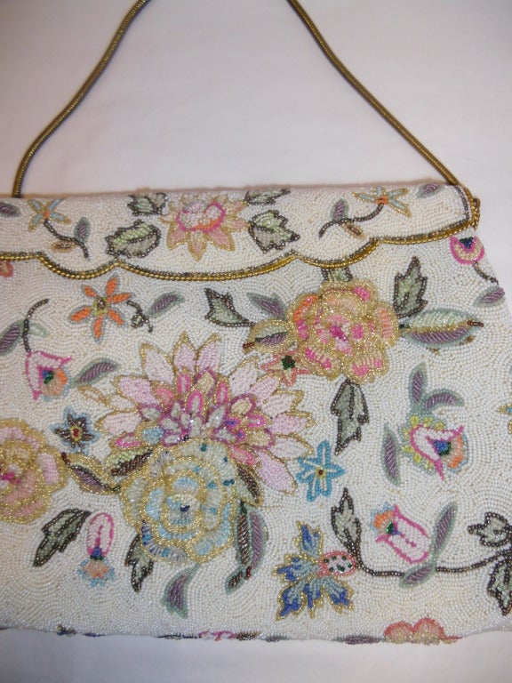 Pristine condition  a must have Vintage Pastel colors floral micro caviar beads bag. So adorable for summer.  Silk lining .  Bag measures 11